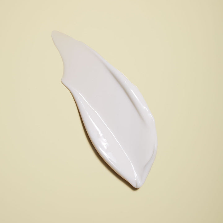 Jackfir Classic Daily Facial Moisturizer white cream smeared in smooth curved stroke showing lightweight texture