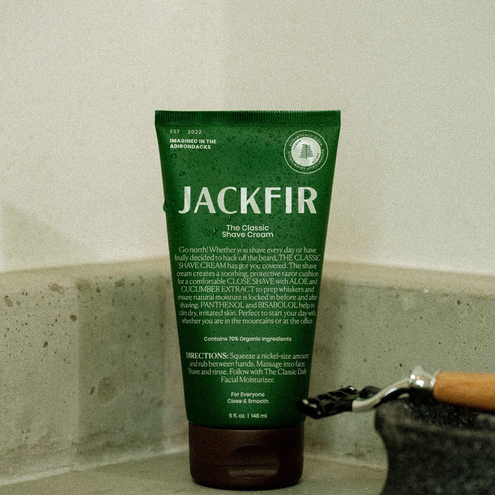 Jackfir Classic Shave Cream green tube standing upright with safety razor partially visible beside it