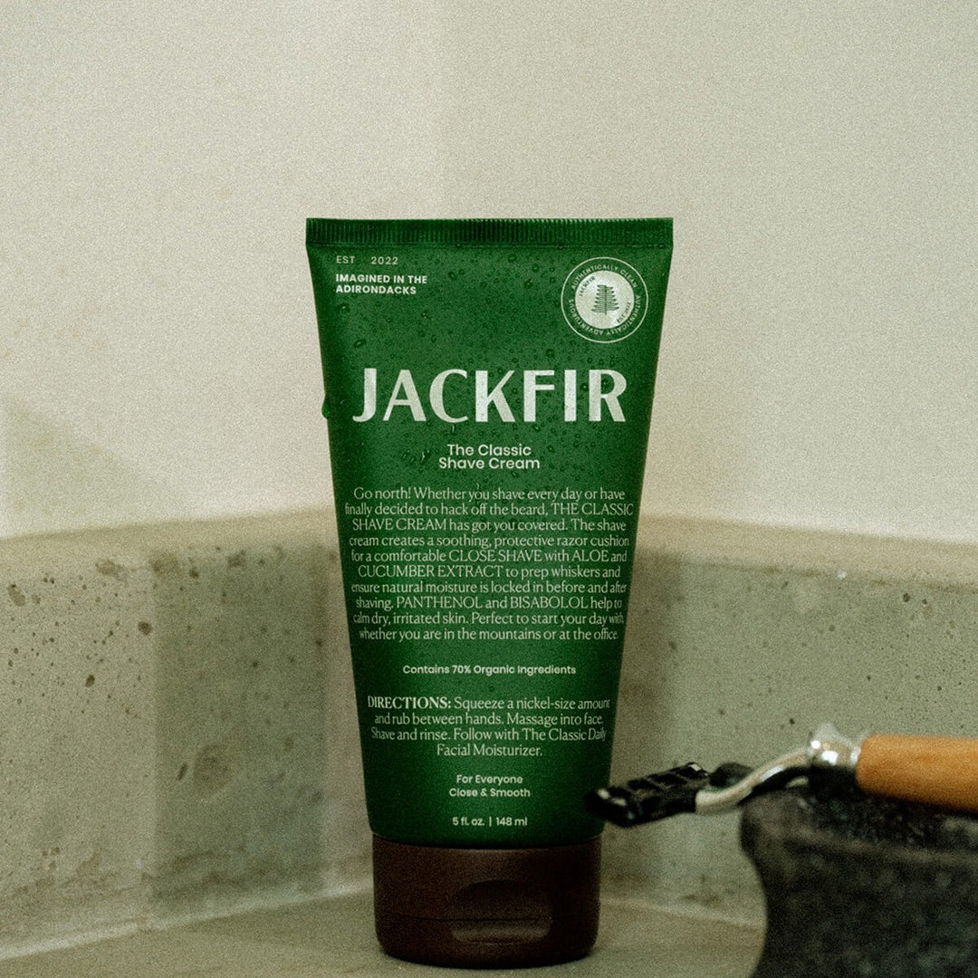Jackfir Classic Shave Cream green tube standing upright with safety razor partially visible beside it