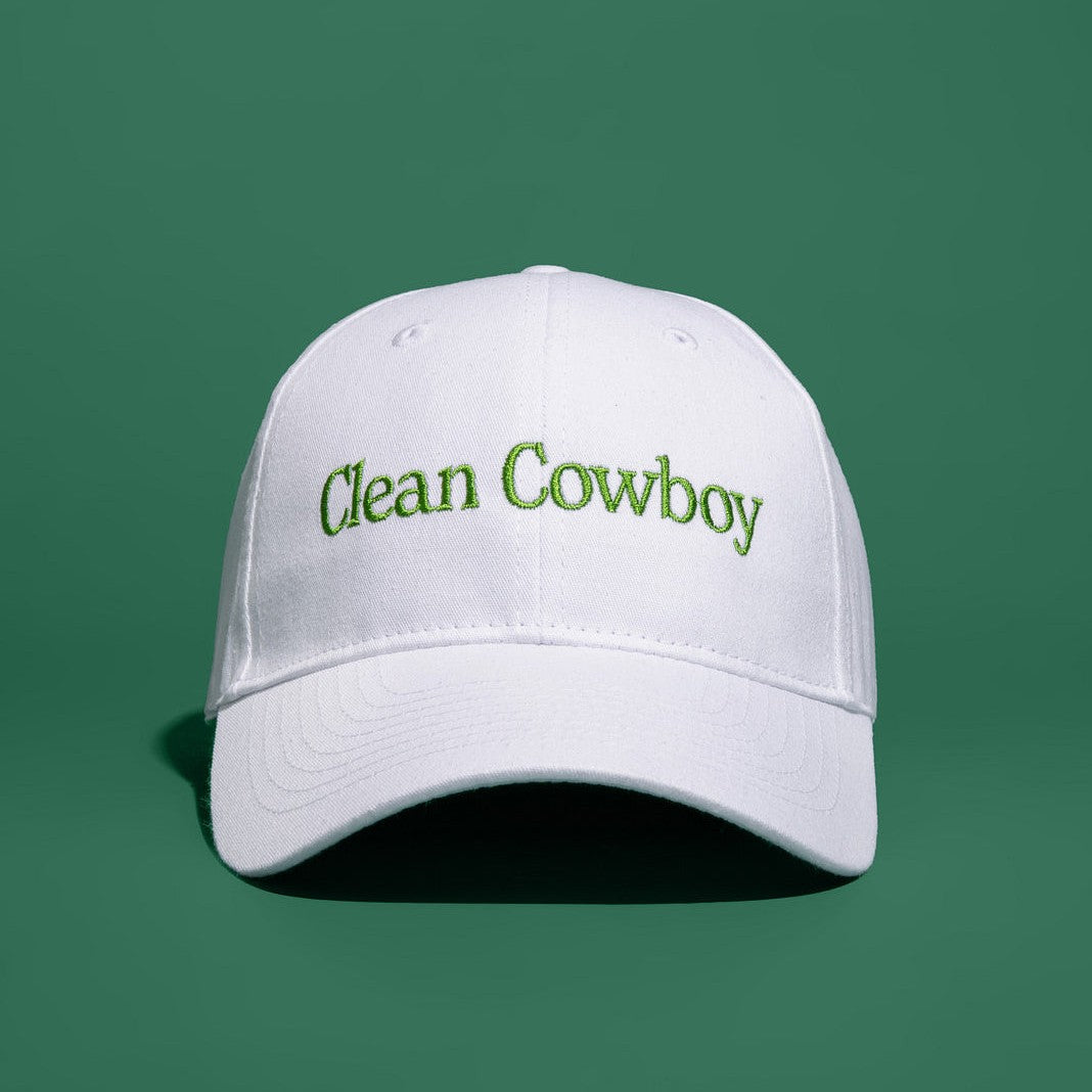 Jackfir Clean Cowboy® Hat in white cotton with green embroidered text shown from front angle