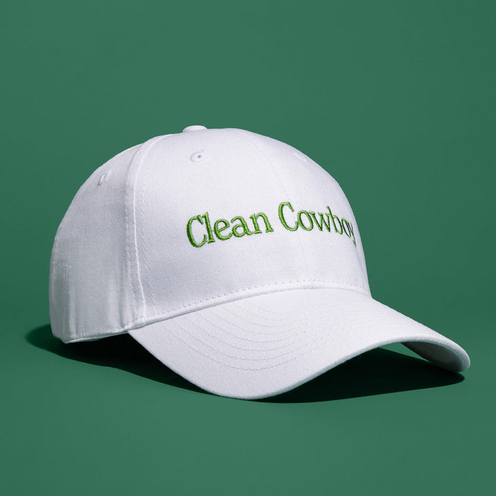White Jackfir Clean Cowboy® Hat with green embroidery shown at side angle casting shadow