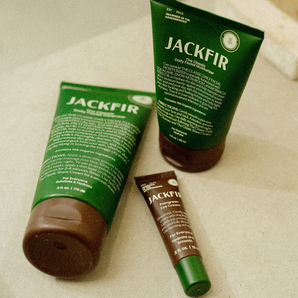 Jackfir Cleanser + Moisturizer + Eye Cream Set with three green tubes laying flat showing product details and branding
