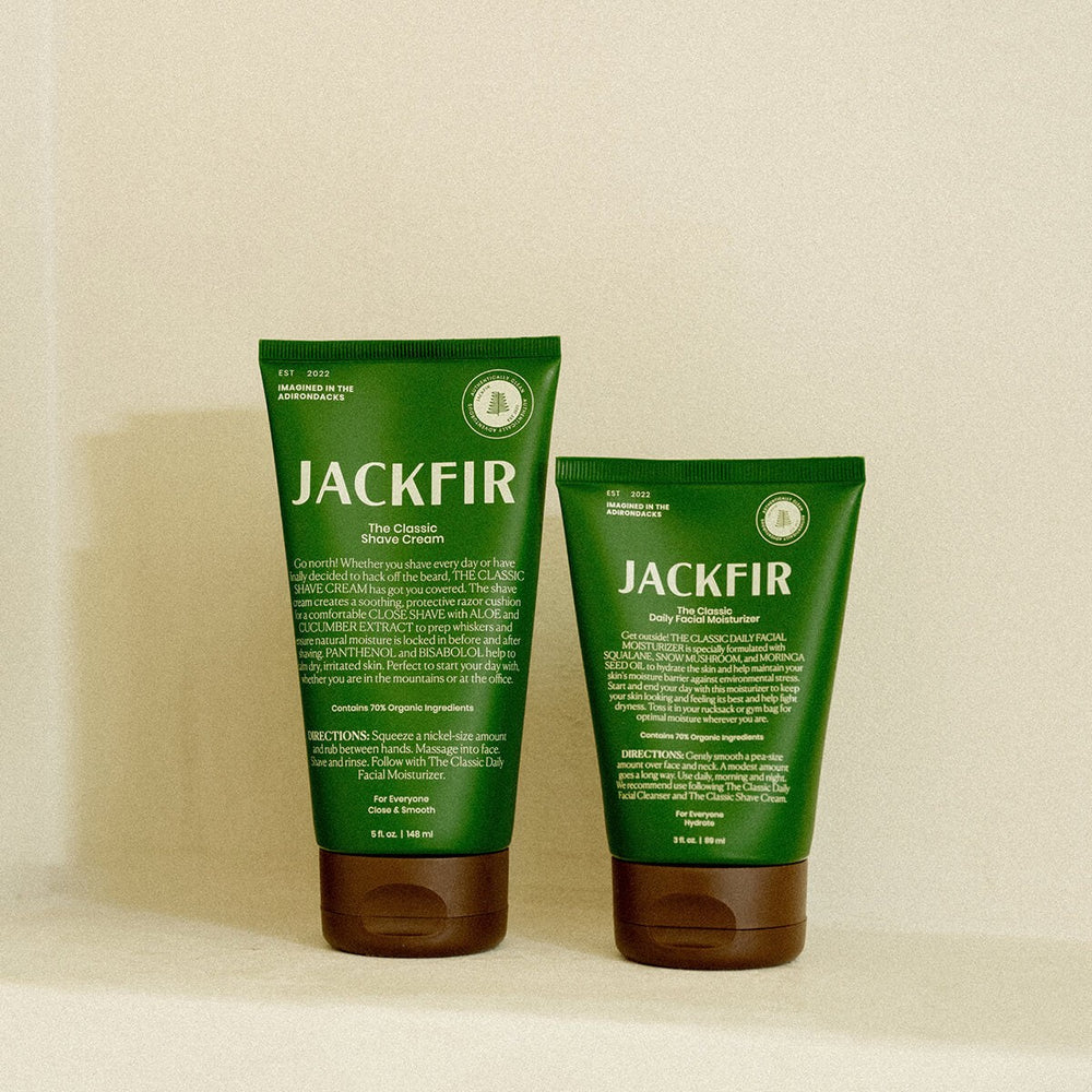 Jackfir Shave Cream + Moisturizer Duo tubes with dark green packaging and brown caps standing side by side