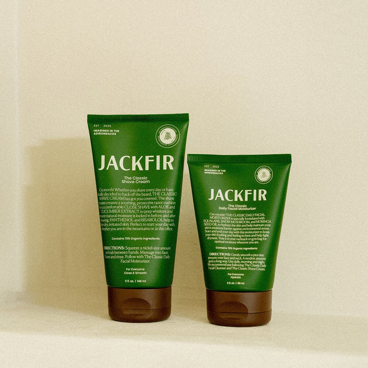 Jackfir Shave Cream + Moisturizer Duo tubes with dark green packaging and brown caps standing side by side