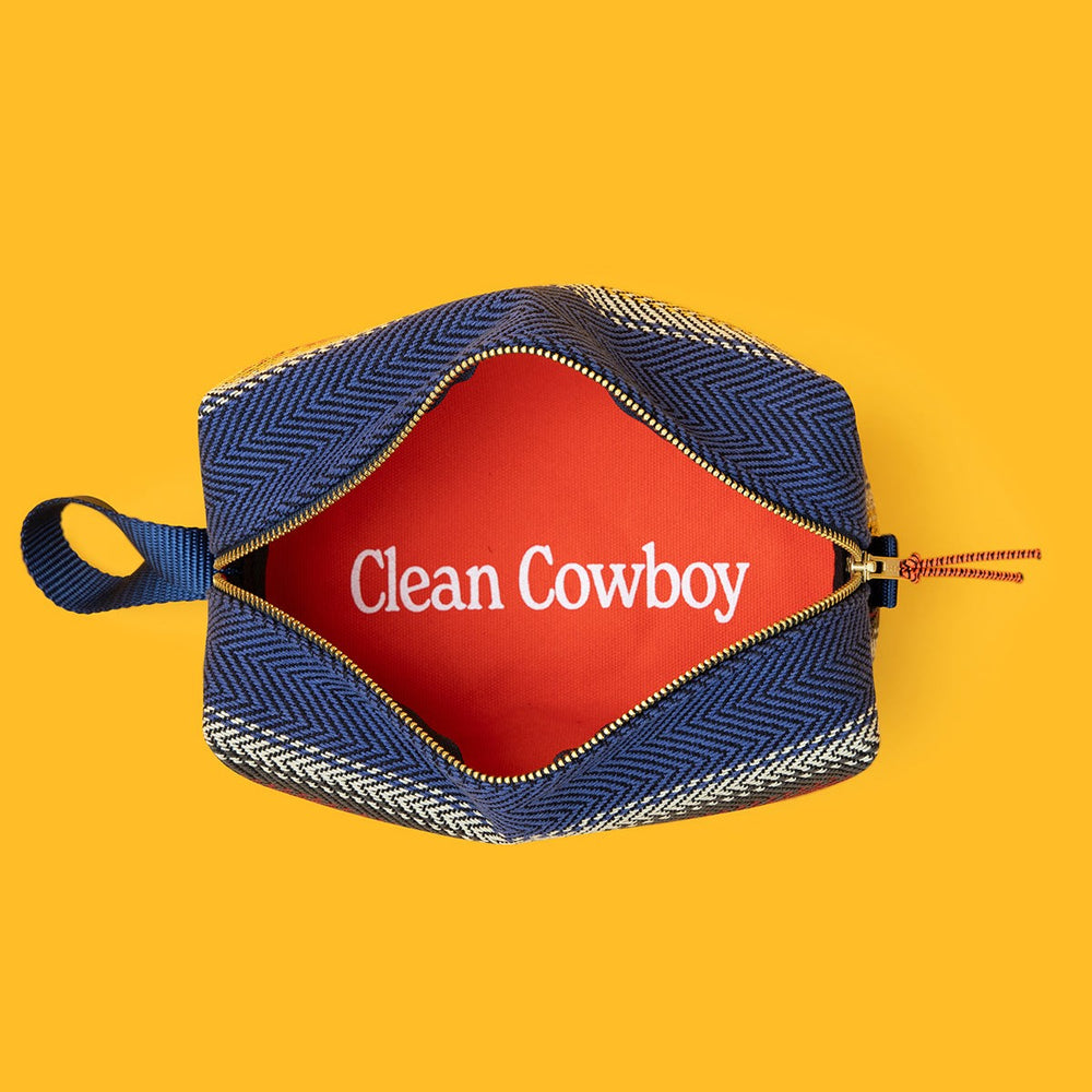 Jackfir The Clean Cowboy® Toiletry Kit unzipped showing red interior lining with white Clean Cowboy text