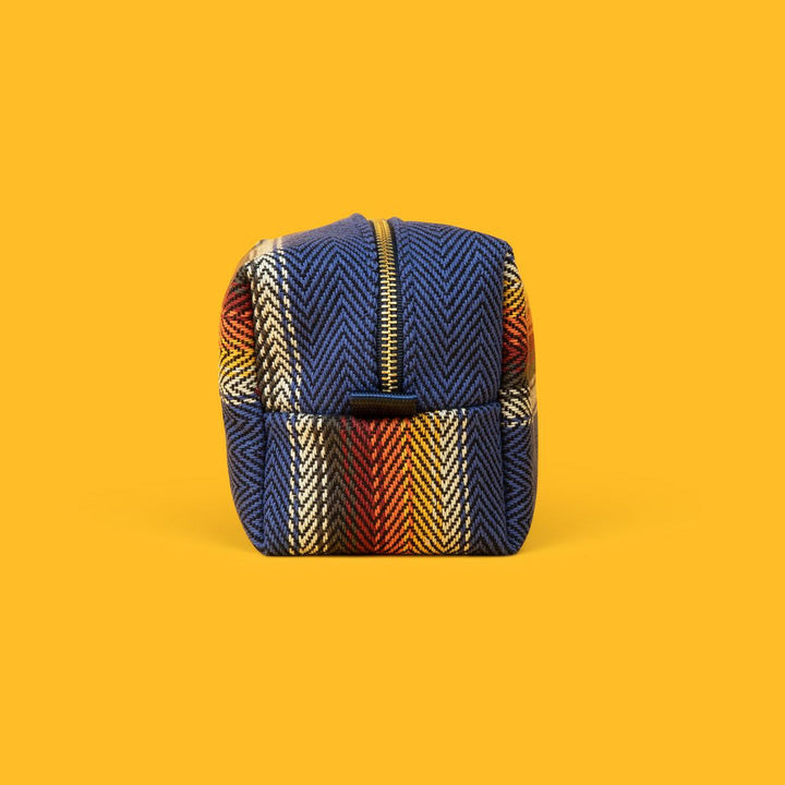 Jackfir The Clean Cowboy® Toiletry Kit zipped closed showing blue herringbone cotton with colorful striped pattern