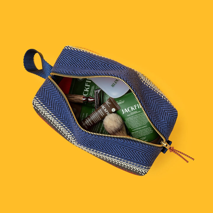Jackfir The Clean Cowboy® Toiletry Kit unzipped showing Jackfir products and shaving brush inside blue herringbone bag