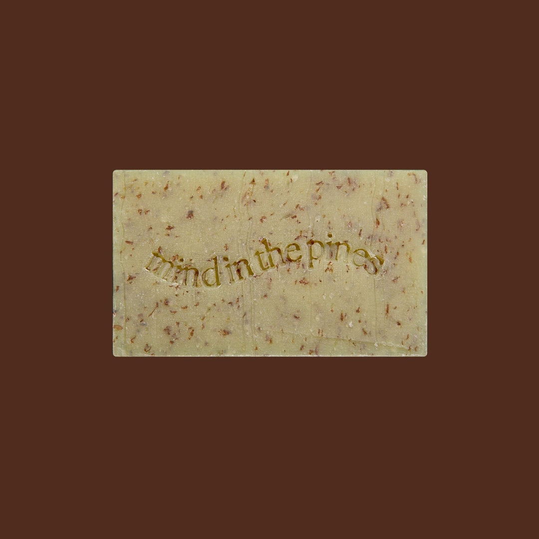 Jackfir The Total Package soap bar with gold embossed text and natural brown speckles viewed from above
