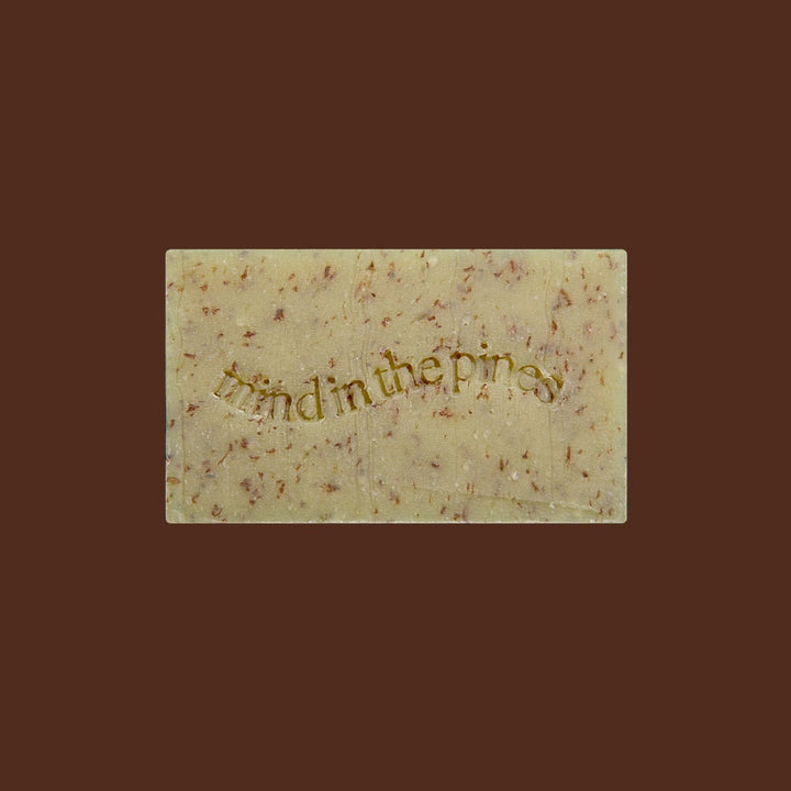 Jackfir The Total Package soap bar with gold embossed text and natural brown speckles viewed from above